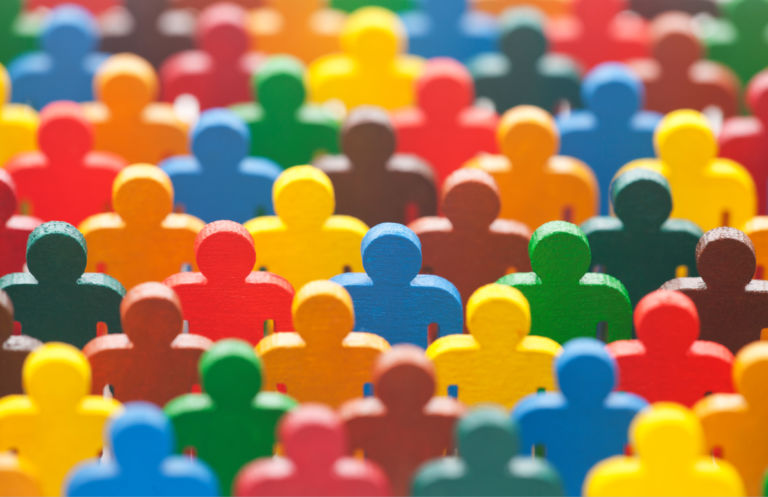 Group of plastic silhouttes in bright colours representing a group of people