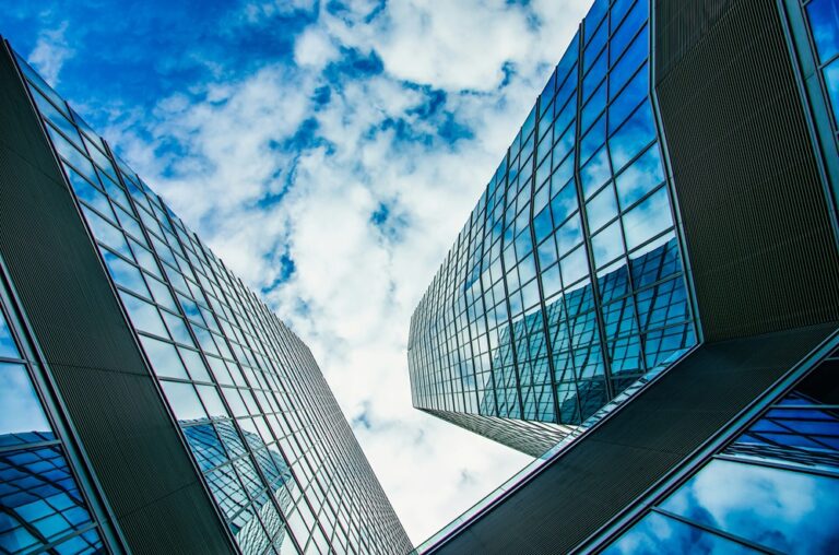 glass tower blocks office buildings against a blue sky