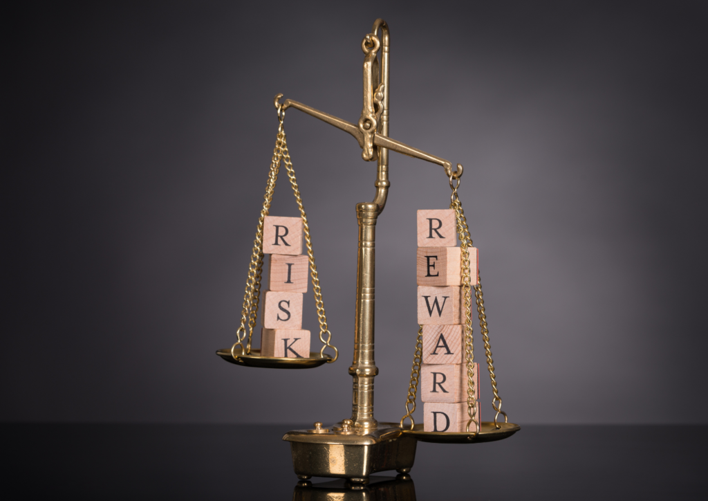 pair of legal justice scales with letter dice one spelling risk one spelling reward