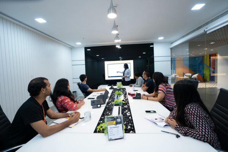 Group of people sitting around a boardroom table