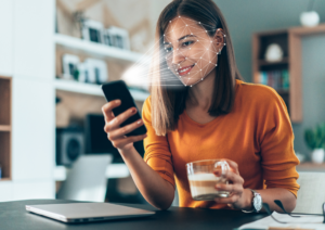 Woman smiling into mobile phone conducting scan of of face