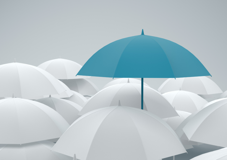 Prominent turqoise umbrella standing tall against white umbrellas