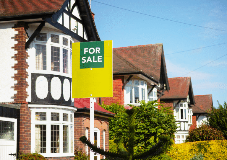 Row of houses in a nice residential area one with for sale sign in front garden