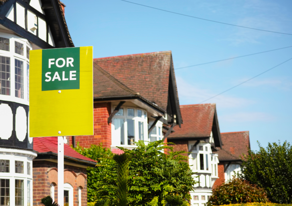 Row of houses with a for sale sign