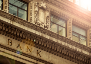 Image of the outside of a traditional building with the word bank etched into the stone fascia